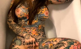 Buxom Tattooed Brunette Making Herself Cum In The Bathtub